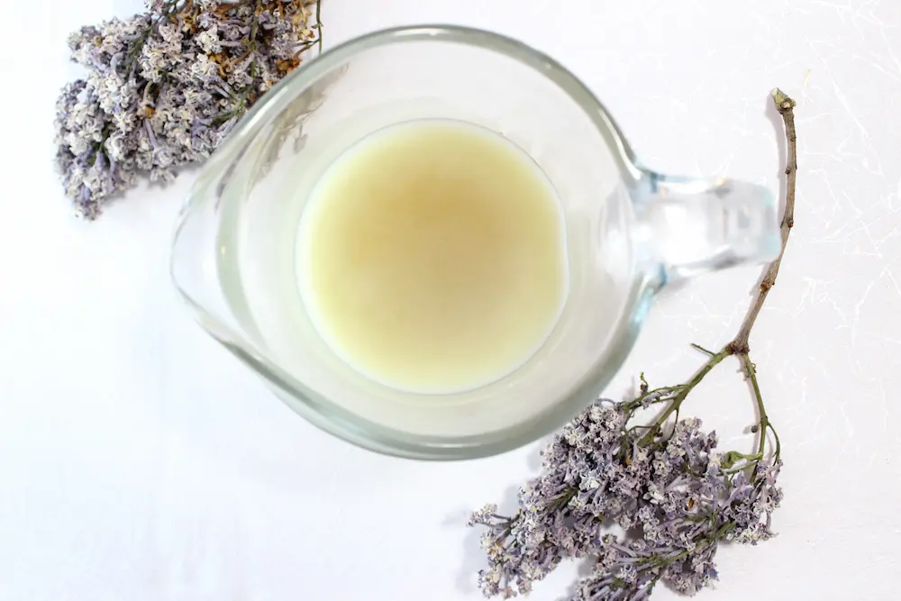 photo of making diy lilac lotion in a glass cup