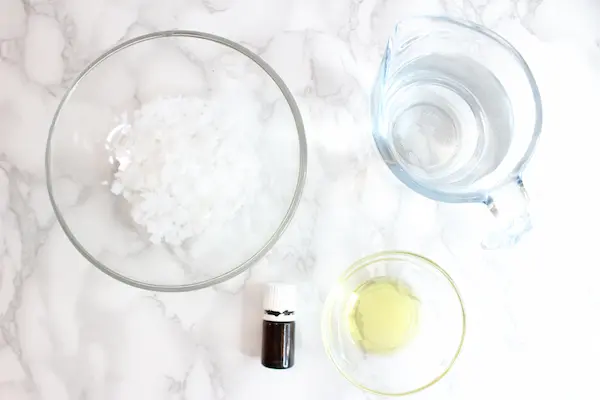 bowls of ingredients and essential oils needed to make magnesium spray.
