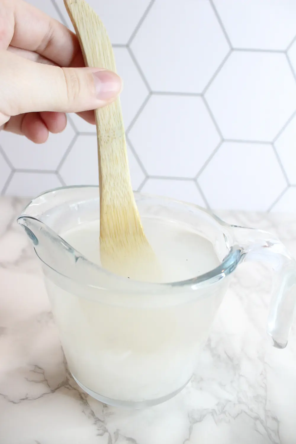 stirring magnesium flakes into a glass jar of boiling water