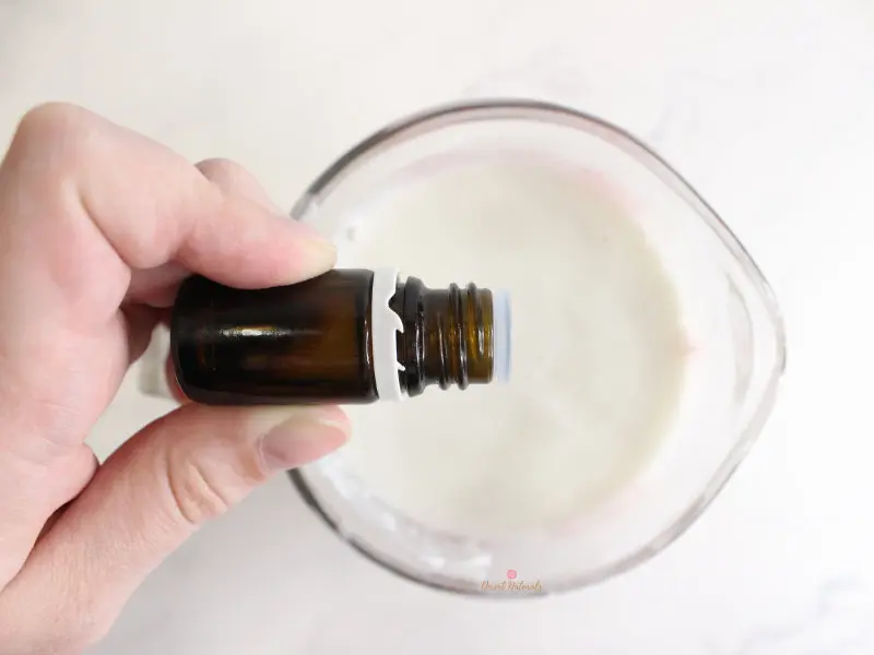 adding essential oil to the melted soap base for diy shampoo bars