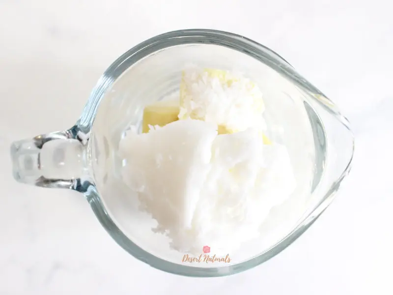 raw ingredients for diy hair conditioner bars in a glass measuring cup