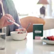 photo of man adding doTERRA PB Assist probiotic to his breakfast cereal.