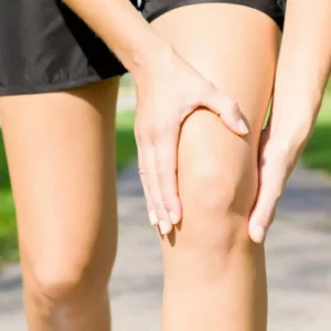 a person holding a sore knee