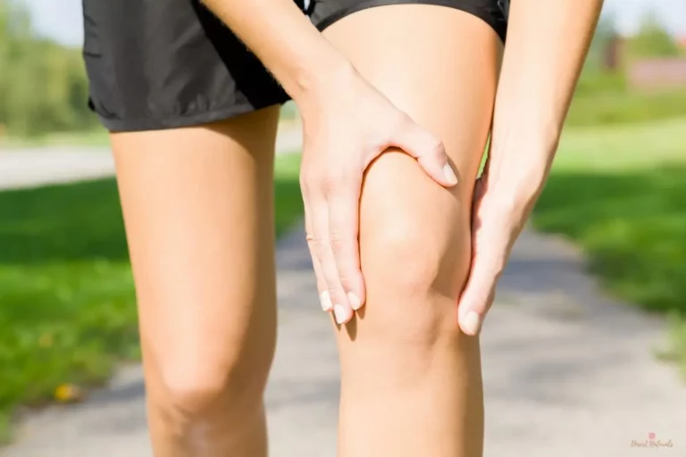a person holding a sore knee