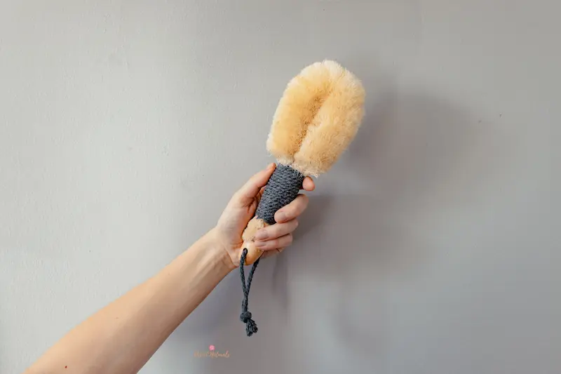 woman's hand holding a dry brush