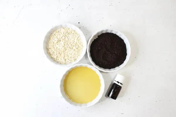 photo of bowls of coffee, oats, oil and essential oil for homemade coffee oatmeal face and body scrub