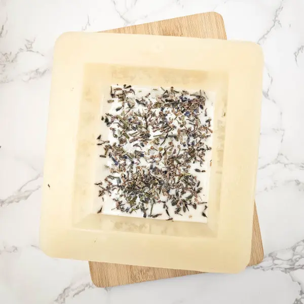 soap mold with melted soap base and dried flowers