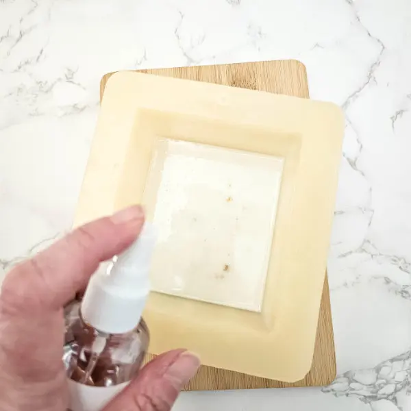 spraying soap in mold with alcohol
