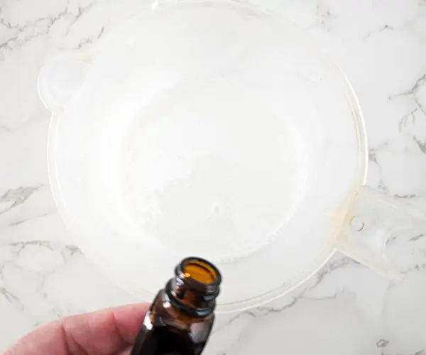 photo of adding essential oil to melted soap base for making lavender eucalyptus chamomile soap