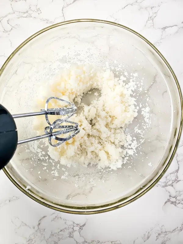 photo of ingredients in a bowl being blended to make lemon vanilla sugar scrub