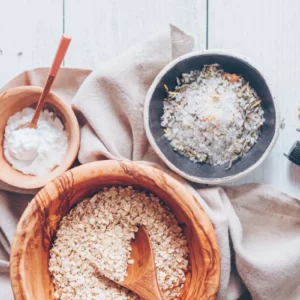 bowls of oatmeal, salts and essential oils for making a diy oatmeal bath soak