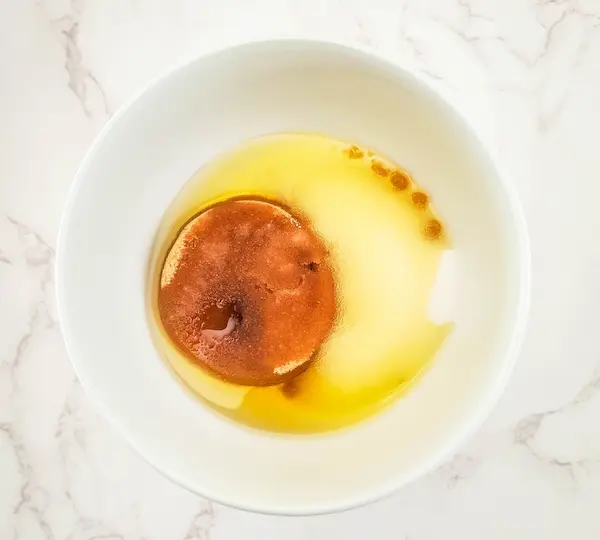 a bowl with carrier oil and sugar in it for making a sugar scrub