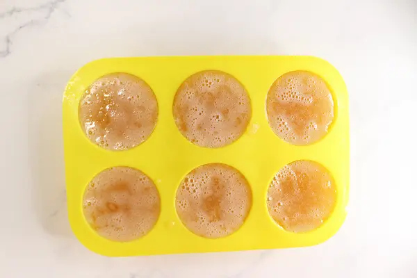 yellow soap mold with sea moss soap  mixture in it