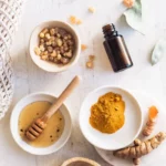 a group of bowls with turmeric, honey, and essential oil to make a turmeric face mask