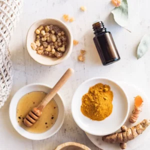 a group of bowls with turmeric, honey, and essential oil to make a turmeric face mask