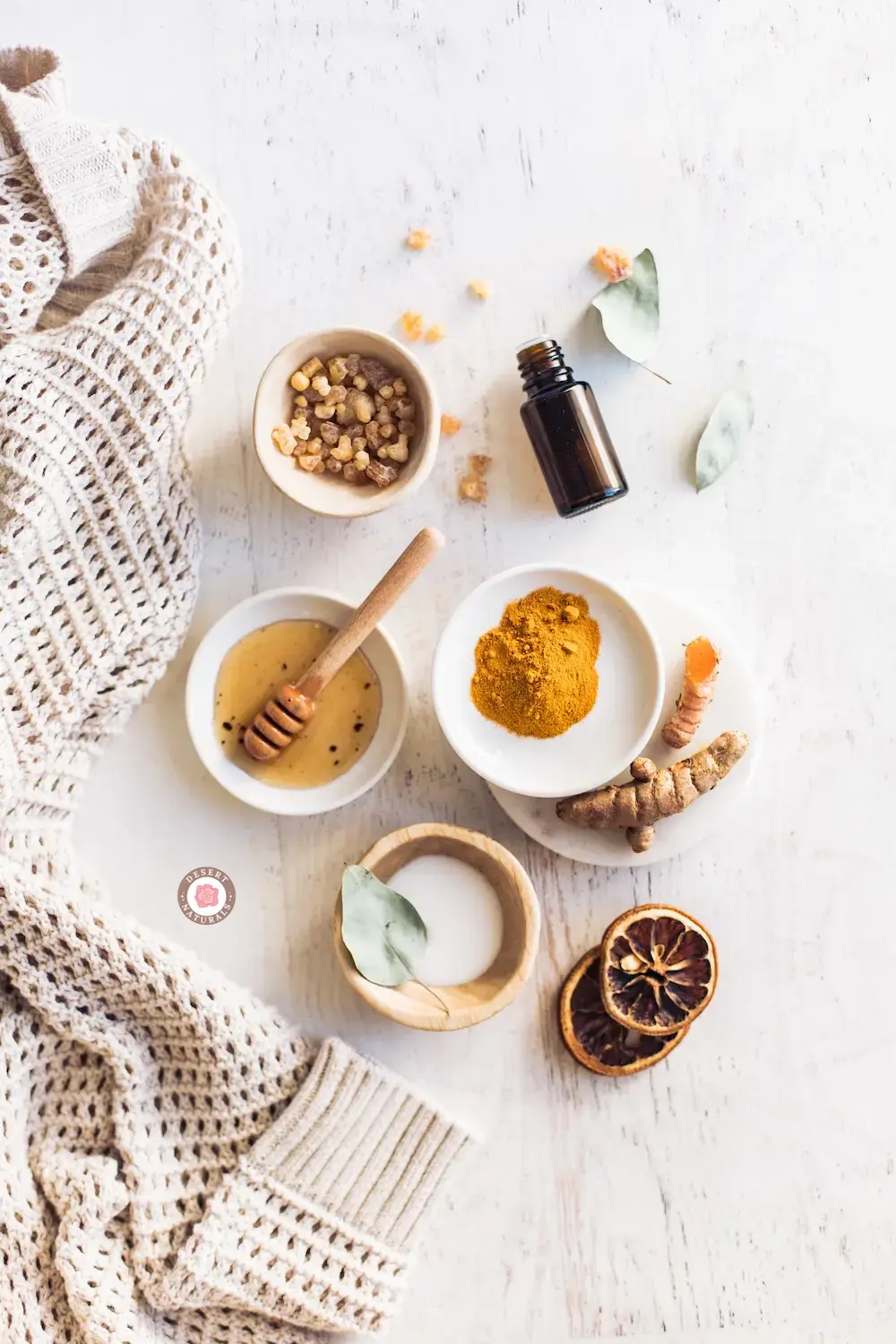 bowls of honey, turmeric and essential oil for a tightening turmeric face mask