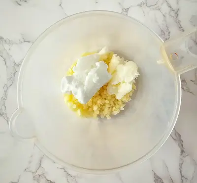 a bowl of natural butters and oils for making lotion bars