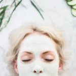 woman using a homemade aloe vera match green tea face mask