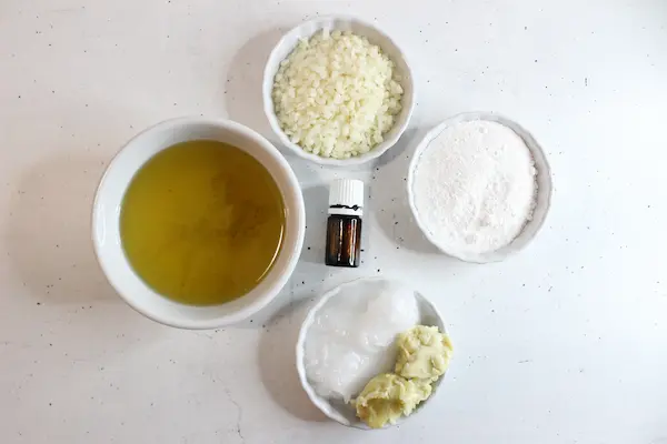 bowls of ingredients and essential oils needed to make diy natural sunscreen