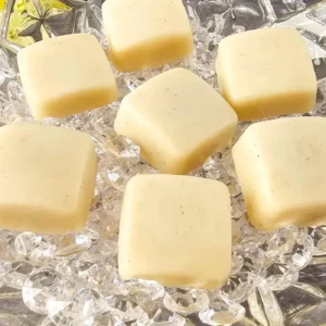 homemade vanilla bean lotion bars on a crystal plate