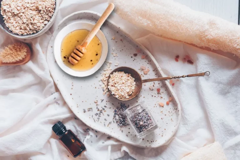 a bowl of oatmeal with honey and lavender essential oil on a white plate