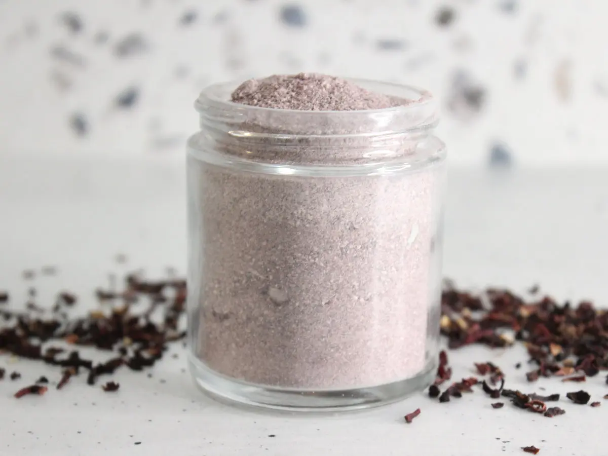 jar of homemade hibiscus cleansing scrub with dried hibiscus flowers