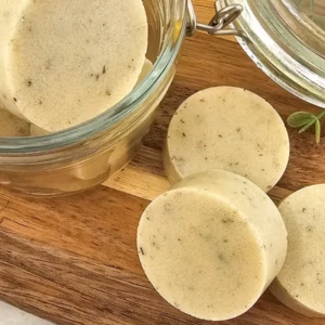 round homemade sugar scrub bars on a wooden cutting board