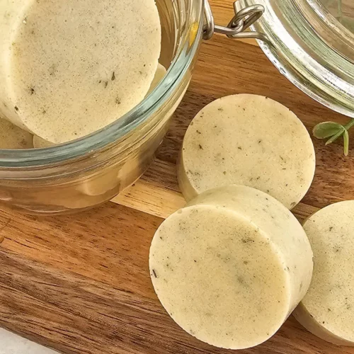 round homemade sugar scrub bars on a wooden cutting board