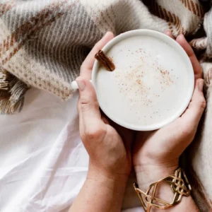 a person holding a cup of pumpkin latte