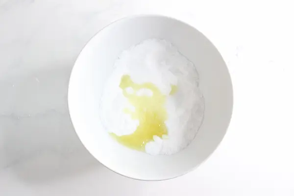 a bowl of epsom salt with essential oil added to it