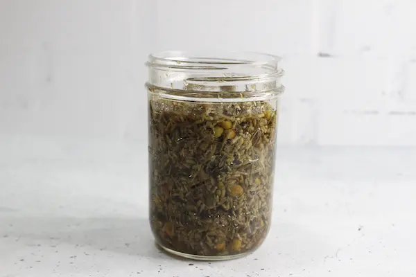 a jar of dried chamomile lavender tea brewing