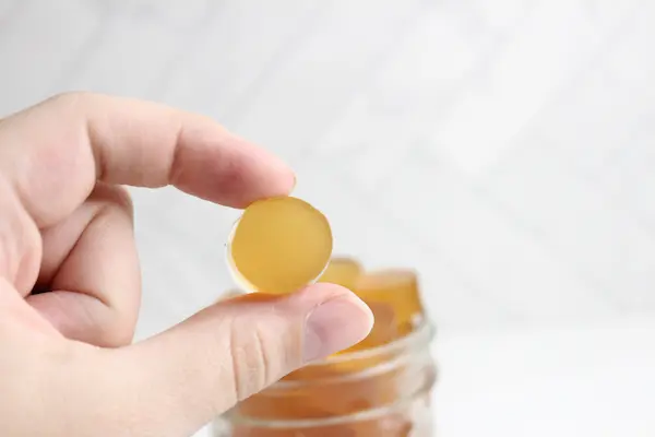 a hand holding a homemade sleep gummy