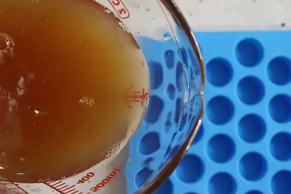 pouring sleep gummies mixture into a silicone mold