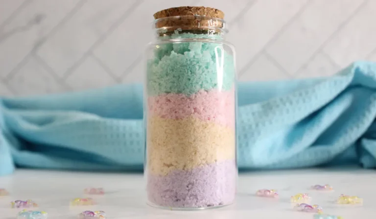 a glass jar with colorful rainbow bath salts in it