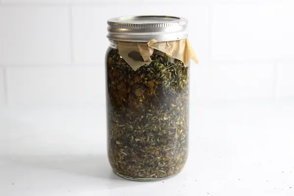 jar of herbs and oil to make an herbal infusion to use in a diaper rash cream