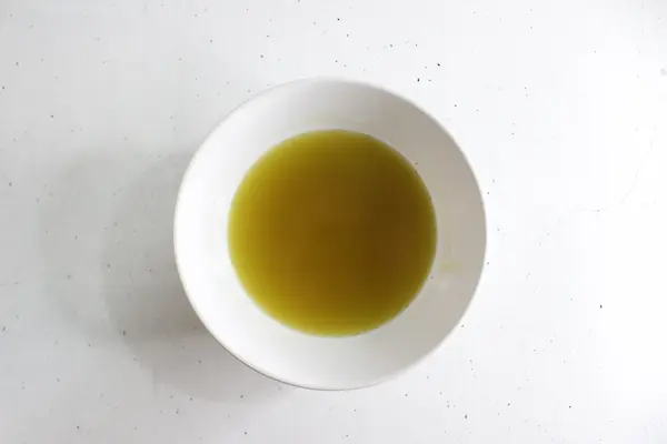 bowl of melted butters and oil for making diaper rash cream