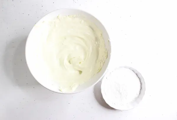 a bowl of homemade diaper rash cream with a small bowl of zinc oxide powder next to it
