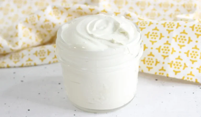 jar of homemade diaper rash cream with a yellow background