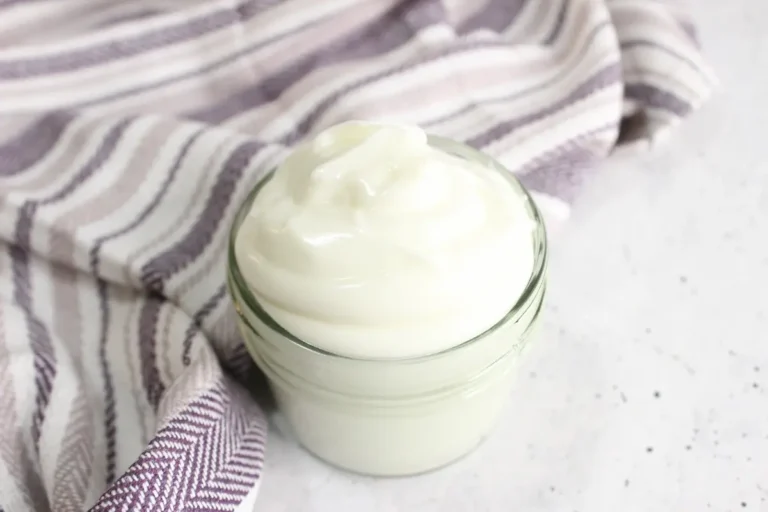 jar of diy tallow balm with a purple striped towel