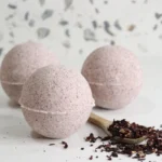 homemade hibiscus bath bombs on white background with dried hibiscus flowers
