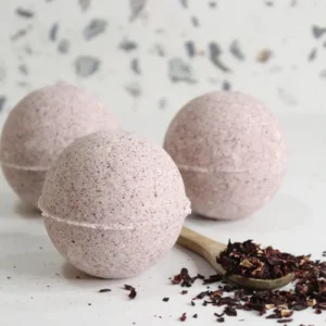 homemade hibiscus bath bombs on white background with dried hibiscus flowers