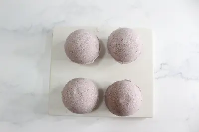 4 hibiscus bath bombs laying on parchment paper