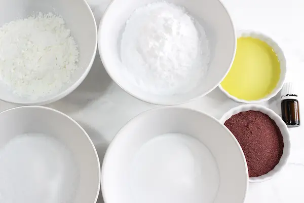 bowls of ingredients needed to make hibiscus bath bombs