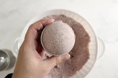 hibiscus bath bomb mixture in a bath bomb mold