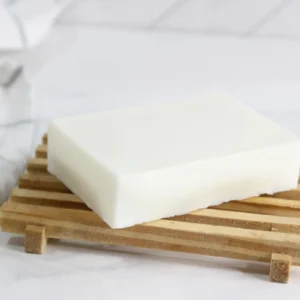 bar of homemade tallow soap on wooden soap holder