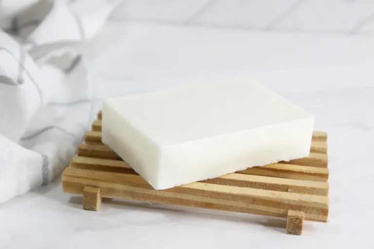 bar of homemade tallow soap on wooden soap holder