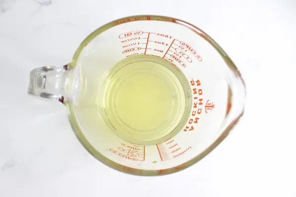 melted tallow in a glass measuring cup