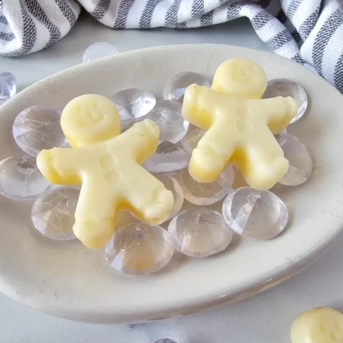 Homemade Gingerbread Lotion Bars in a bowl with glass beads