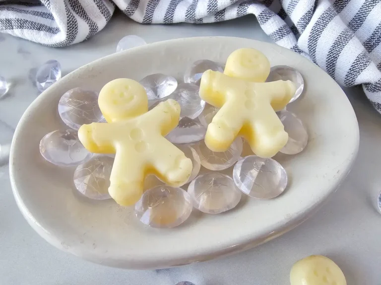 Homemade Gingerbread Lotion Bars in a bowl with glass beads