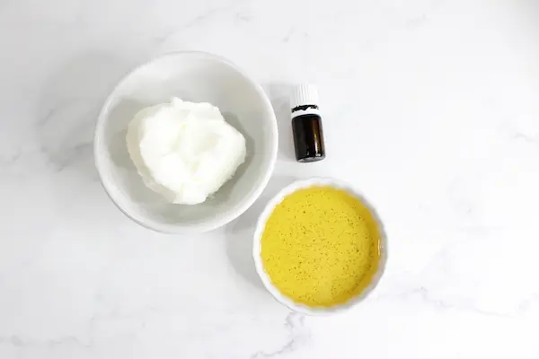 bowls of oils and tallow and essential oil needed to make tallow face cream